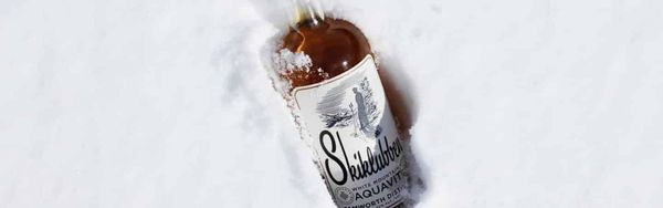 Tamworth Distilling Skiklubben Aquavit Bottle in the Snow Photo